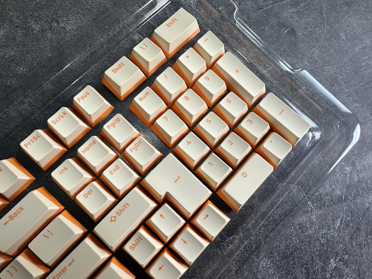 Custard yellow PBT double-shot keycaps. Durable, opaque PBT and warm dual-tone cream aesthetic displayed from multiple angles.