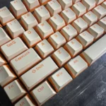 Gallery of durable Custard Yellow PBT double-shot keycaps keyboards, featuring their warm, opaque dual-tone cream aesthetic from variant angles.
