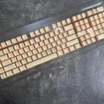 Main image featuring premium custard yellow PBT double-shot keycaps, highlighting their durable build and warm dual-tone aesthetic with crisp.