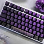 Close-up views of the Peacock Keycap Set, highlighting the exquisite iridescent side-engraved feather art and intricate details on each elegant keycap.