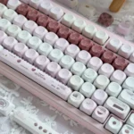A collection of charming pink MOA keycaps showcasing their soft pastel hues and smooth spherical profile from various angles, creating a cheerful typing.
