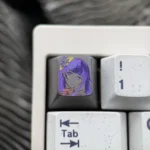 Experience the artistry of this hand-carved Raiden Shogun titanium artisan keycap, featuring intricate lines and a powerful matte finish.