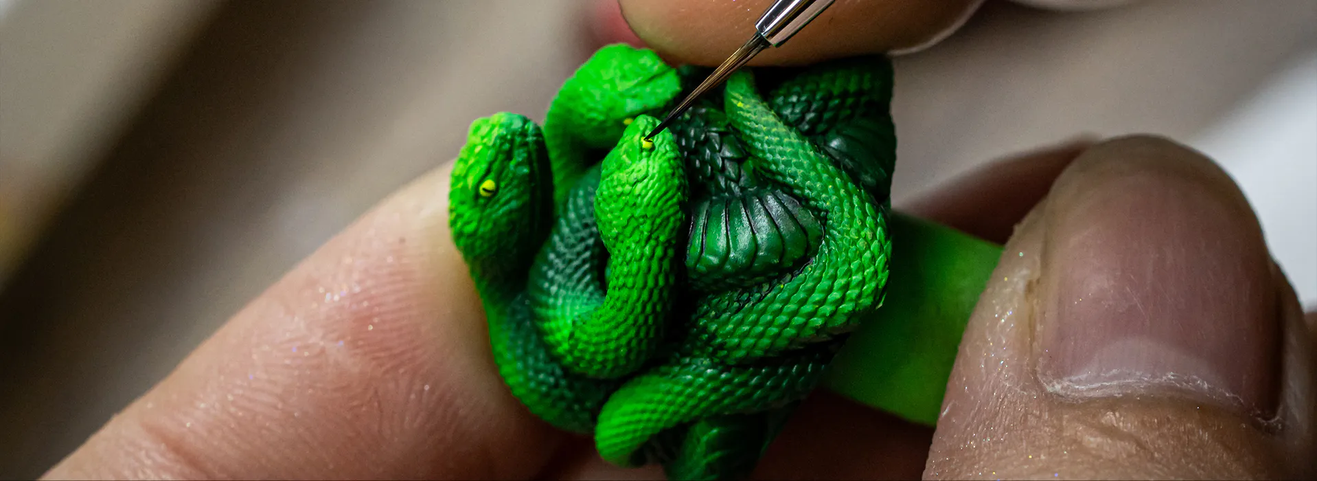 Craftsperson hand-painting details on the Razer artisan keycap