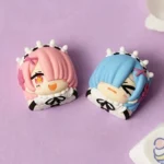 A captivating angle of the exquisite Re:Zero Rem and Ram artisan keycaps, highlighting their vibrant, detailed anime character designs.