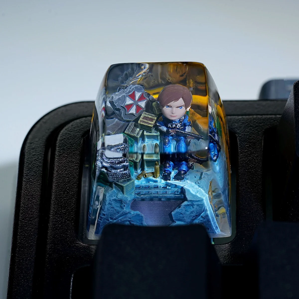 Angled view of the iconic Resident Evil Leon Scott Kennedy artisan keycap, highlighting detailed resin artistry and high transparency. Captures Leon Kennedy's aesthetics.