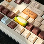 Close-up views of the unique chubby banana hand-painted resin artisan keycap, showcasing its vibrant colors and intricate handcrafted details from multiple angles/