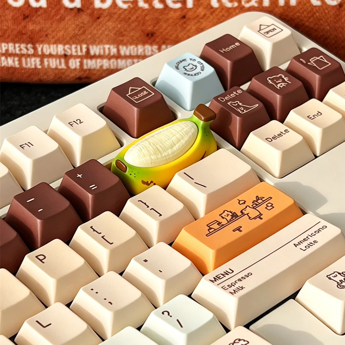 Chubby banana resin artisan keycap, hand-painted. Unique, handcrafted, vibrant yellow, cheerful. Whimsical desktop accent.