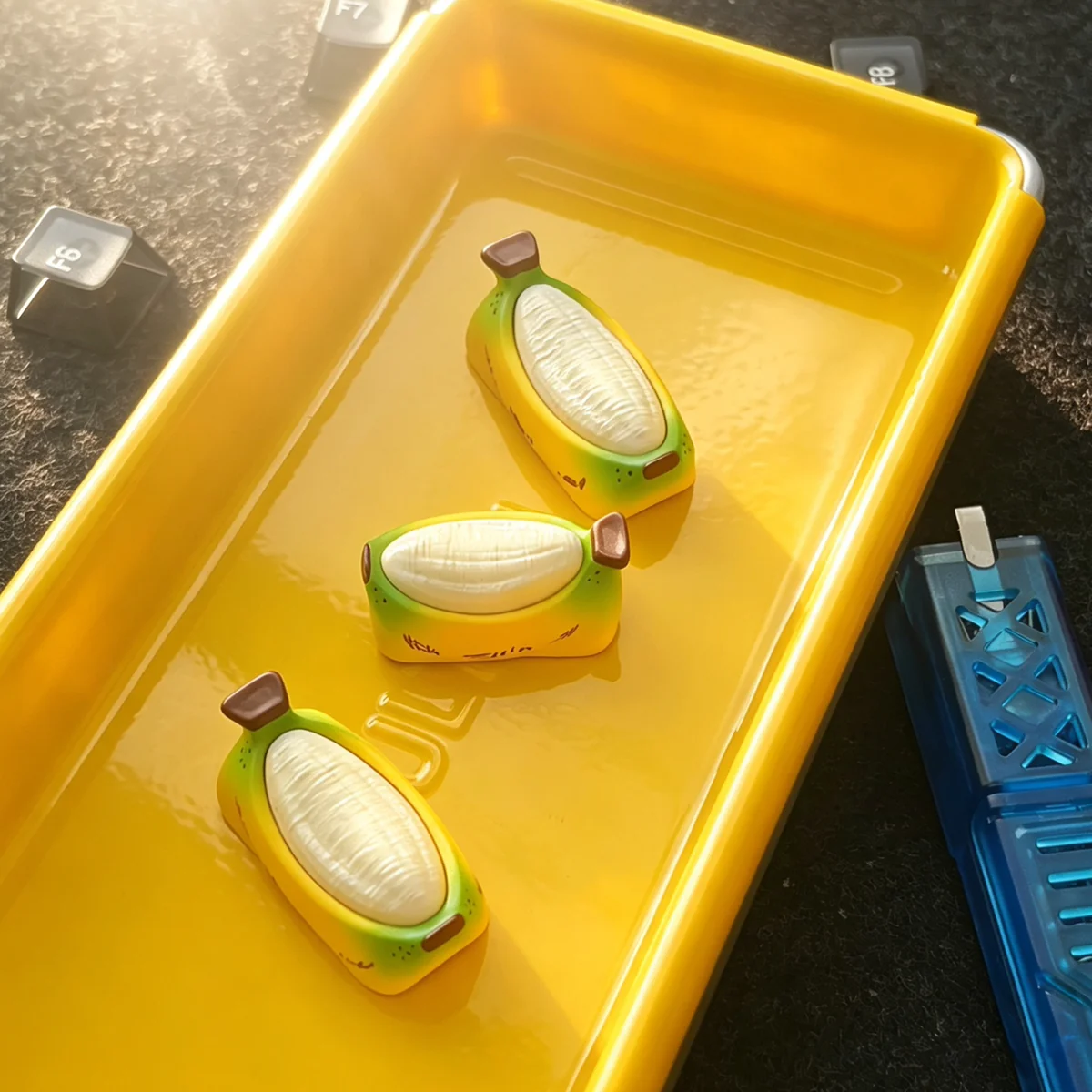Chubby Banana Hand-painted Resin Artisan Keycap. Unique handcrafted resin banana design, vibrant, whimsical details. A cheerful desktop accent.