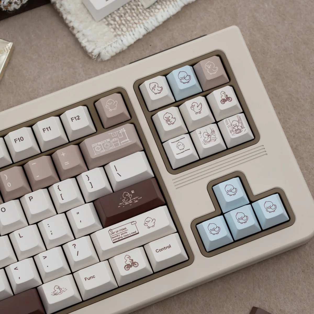 Detailed views of Coco Duck Cherry Keycap Set, showcasing the warm aesthetic and charming duck illustrations from multiple angles.