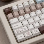 Artistic close-up views of Coco Duck Cherry Keycap Set, showcasing their warm brown and cream aesthetic with charming duck illustration.