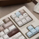 Artistic Coco Duck Cherry Keycap Set from various angles, highlighting their warm aesthetic and charming duck illustrations.