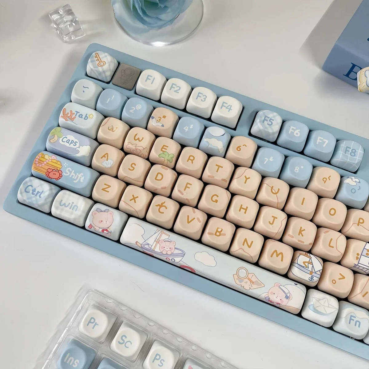 See the charming Sailor Bear MOA Keycap Set from various angles, highlighting its whimsical design, playful ocean hues, and intricate maritime element.