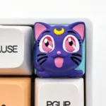 Close-up of a handcrafted 3D resin Sailor Moon Luna keycap, showcasing the whimsical anime cat design with intricate details and artistic craftsmanship.