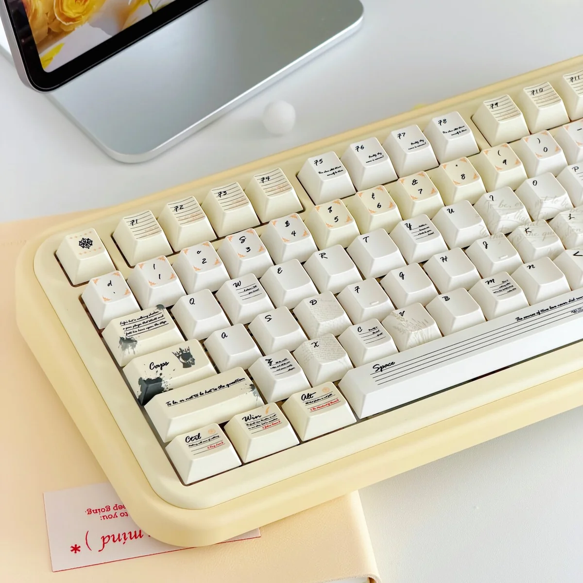 Shakespeare PBT keycaps in vintage milky yellow, shimmering from various angles, highlighting the set's literary elegance and premium finish.