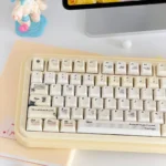 Shakespeare PBT Keycaps Set gallery. Vintage milky yellow, shimmering pearlescent finish, literary accents.