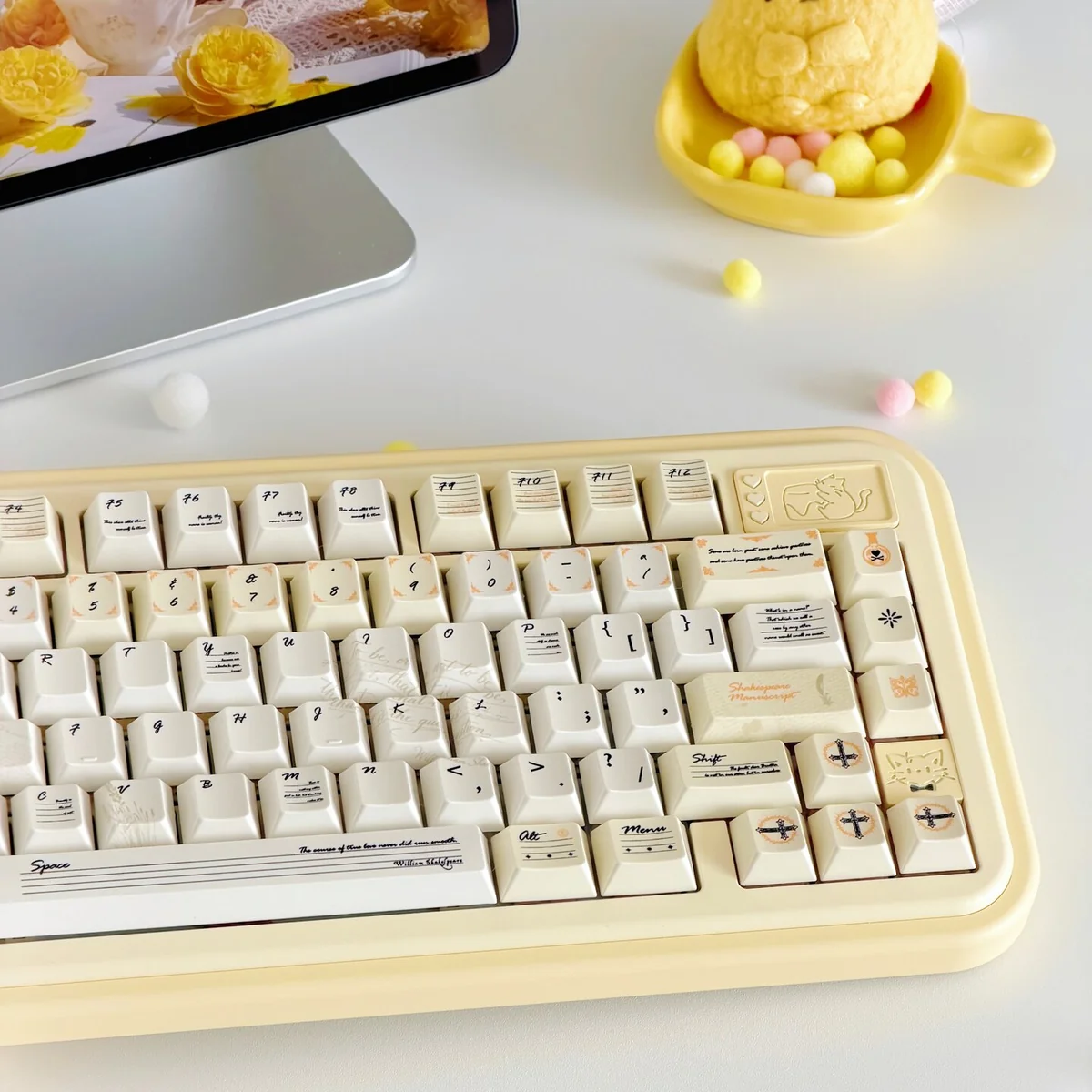 Detailed views of the Shakespeare Keycaps Set, highlighting its vintage milky yellow PBT, pearlescent shimmer, and literary-themed legend.