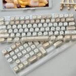 Artistic 120-key Siamese Cat Azukisan PBT keycaps set with an opaque finish, highlighting playful feline designs in warm, earthy tones for a cozy aesthetics.