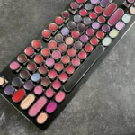 Daring Lipstick Steampunk Mechanical Keyboard from a side angle, revealing its vibrant, glossy keys and retro-futuristic steampunk aesthetic.