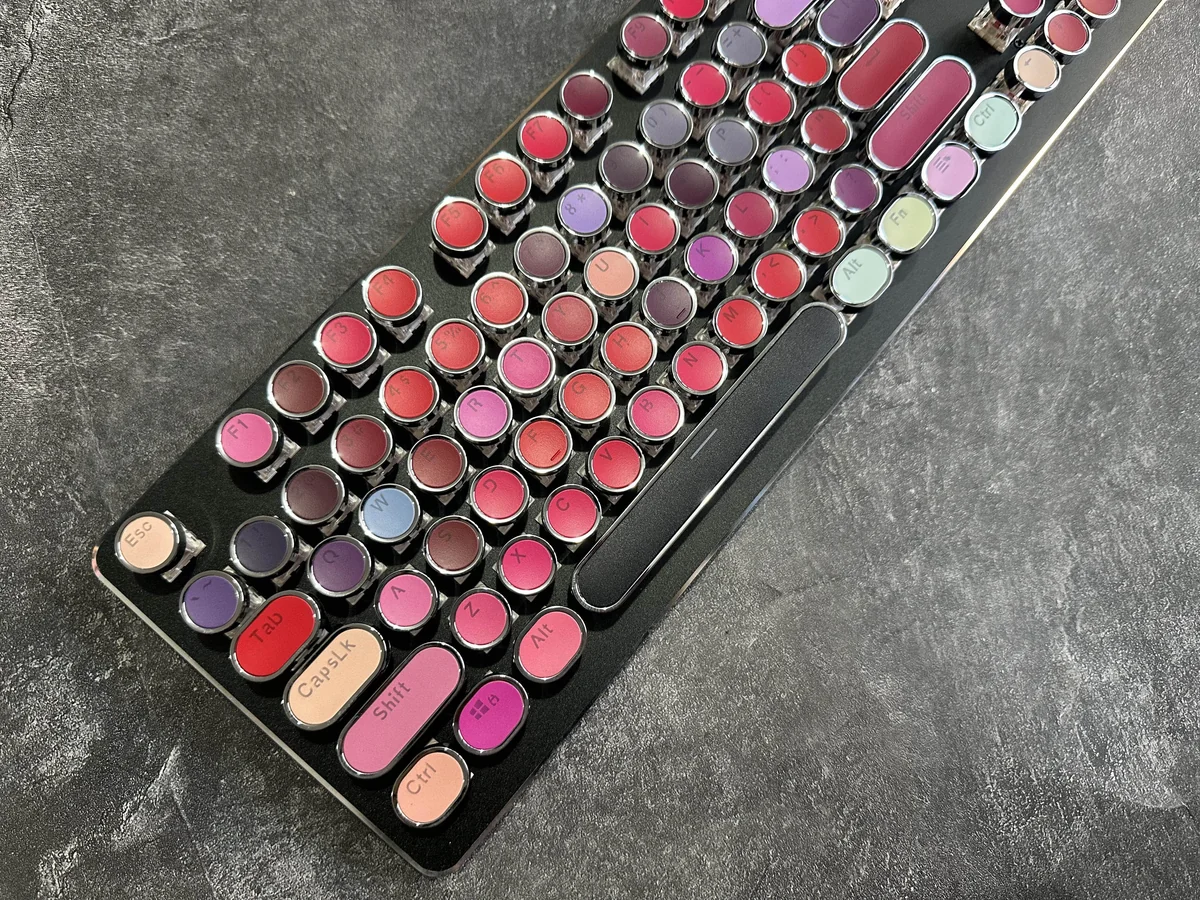 Daring Lipstick Steampunk Mechanical Keyboard from a side angle, revealing its vibrant, glossy keys and retro-futuristic steampunk aesthetic.