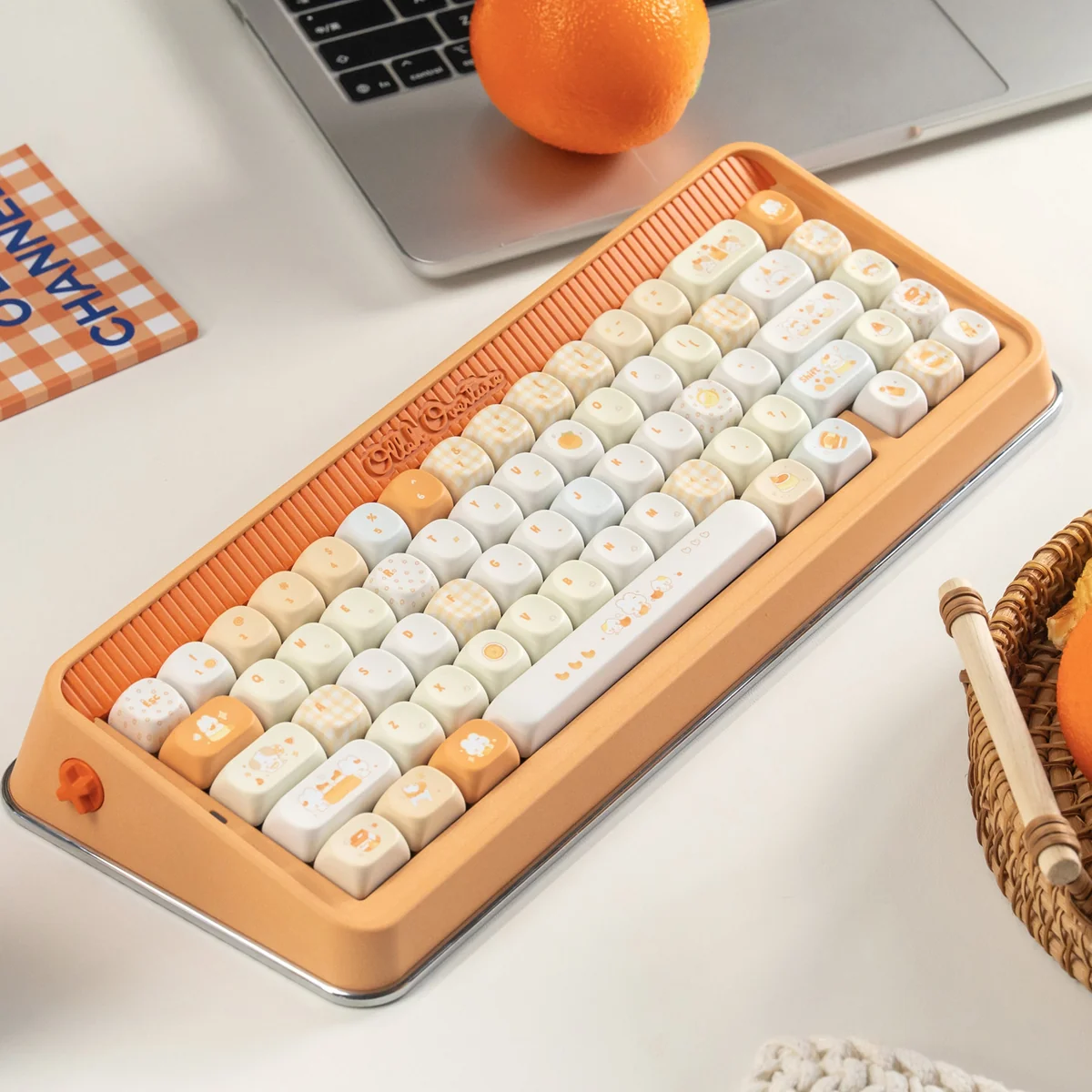 Playful Tangelo Mochi PBT dye-sub keycaps arranged from various angles, showcasing their vibrant orange and cream colors and cute dessert theme.