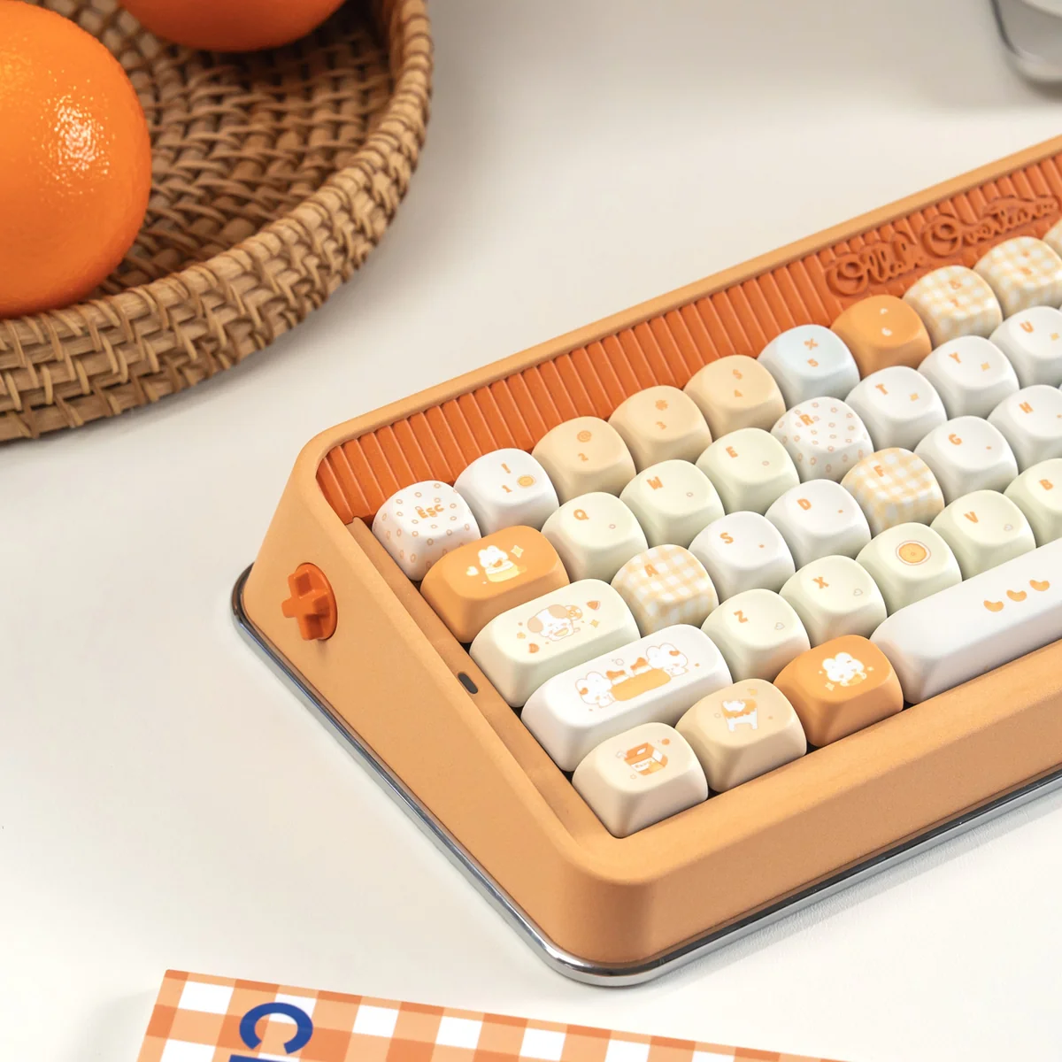 Close-up view of the playful Tangelo Mochi PBT dye-sub keycaps, highlighting their vibrant orange and cream dessert theme. A unique, summery set.