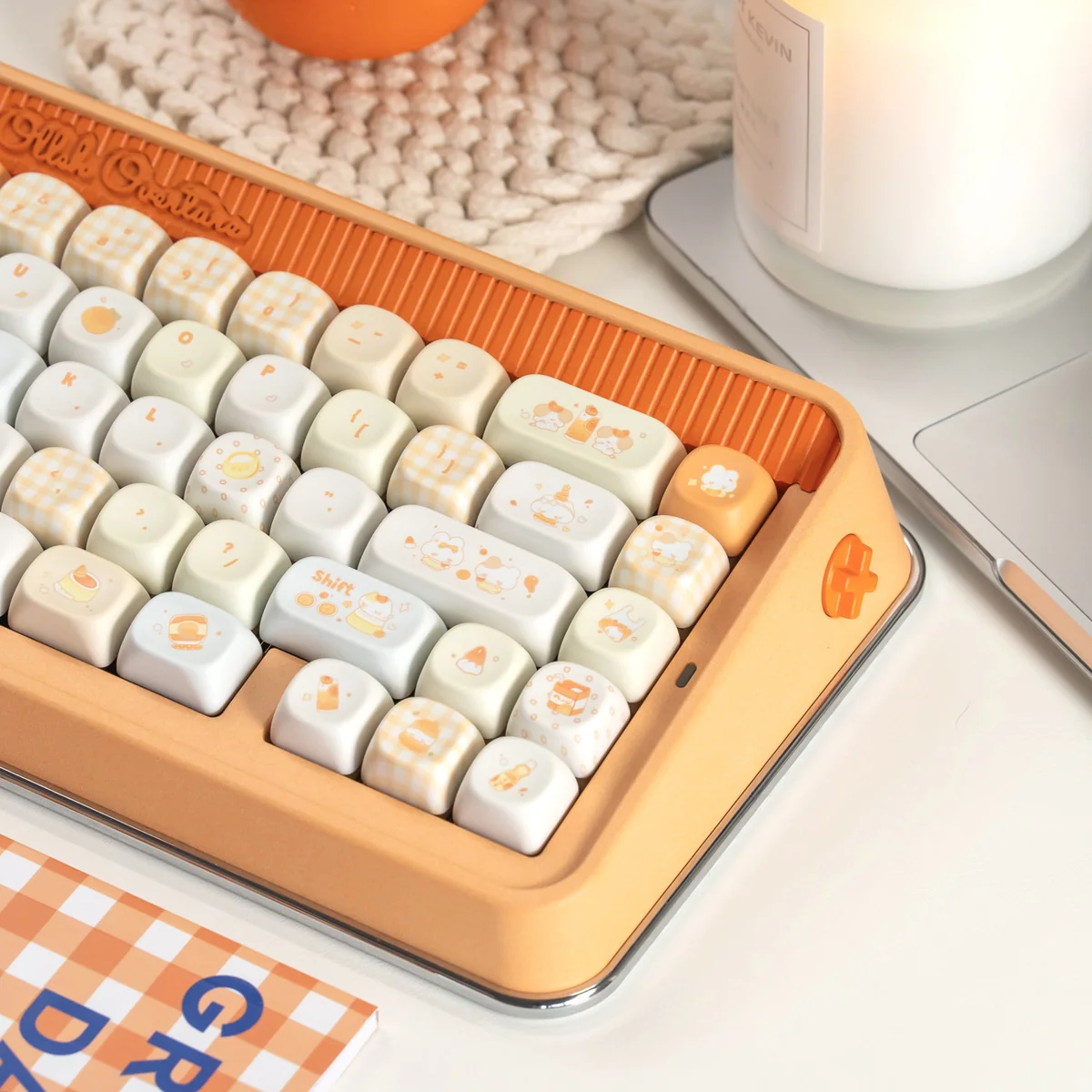 Close-up of playful Tangelo Mochi PBT dye-sub keycaps from multiple angles, showcasing their vibrant orange and cream colors and cute dessert theme.
