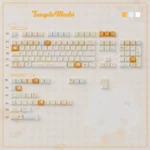 Playful Tangelo Mochi MOA-PC supplement keycaps, featuring vibrant orange and cream PBT dye-sub legends and dessert-inspired novelty designs.