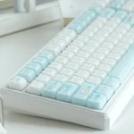 Whimsical UR98 Cat Paradise Tri-Mode Mechanical Keyboard displayed from a charming angle, highlighting its playful feline keycaps, soft inviting colors, and versatile tri-mode connectivity.
