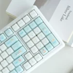 A playful close-up of the whimsical cat paradise mechanical keyboard, showcasing its charming feline keycaps and versatile tri-mode connectivity.