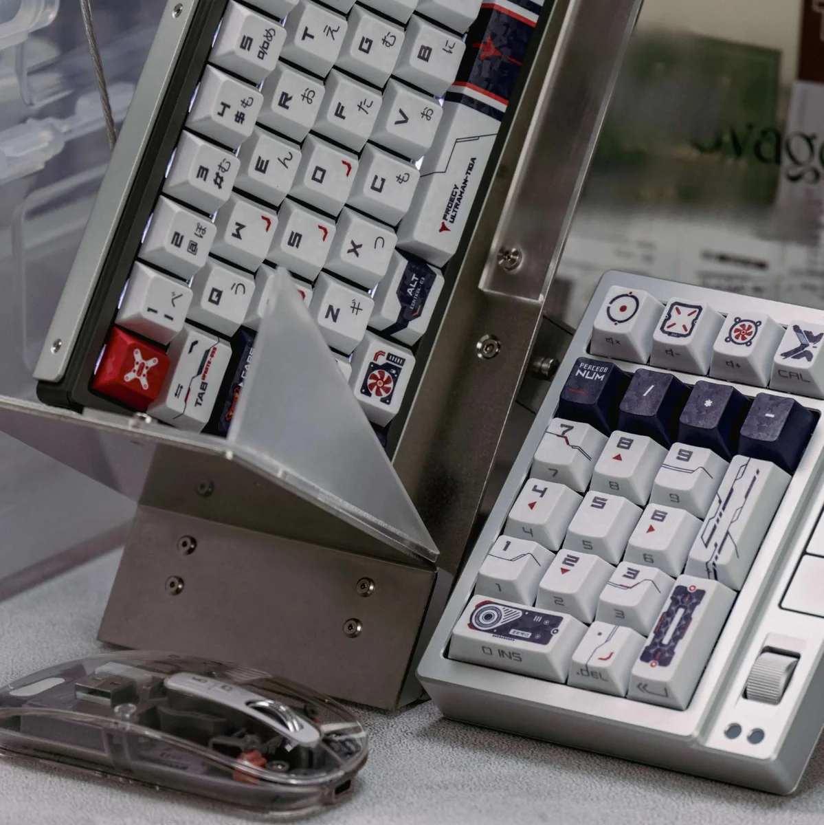 Exclusive Ultraman Tiga GUTS PBT keycaps. Multiple views highlight retro-futuristic side-printed backlit legends and tactical carbon fiber design.