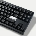 WOB Pure Black PBT Cherry keycaps, multi-angle view. Classic black and white. Durable PBT, crisp Doubleshot legends, refined minimalist style.