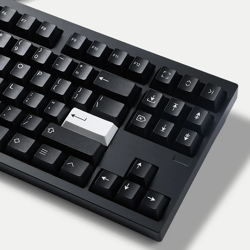 WOB Pure Black PBT Cherry keycaps, multi-angle view. Classic black and white. Durable PBT, crisp Doubleshot legends, refined minimalist style.