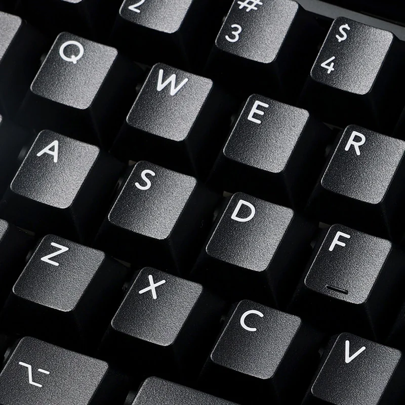 WOB Pure Black PBT Cherry keycaps showcasing their classic black and white aesthetic, highlighting durable PBT material and crisp legends.