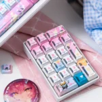Showcasing the Wuthering Waves Aemeath Mecha PBT Keycap Set from an elevated perspective, emphasizing its futuristic mecha design and durable PBT texture.