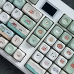 Close-up of the whimsical zoo MOA keycap, showcasing its adorable rounded green animal character and vibrant PBT. A playful accent for any keyboard.