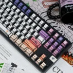 Hand-drawn graffiti keycaps in bold color blocks on a mechanical keyboard, showing vibrant street art icons and contrasting PBT keys.