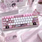 Angels of Delusion Cherry Keycap Set with pastel chibi angel art, translucent side-lit legends, and kawaii pink keyboard styling on a dreamy desktop.