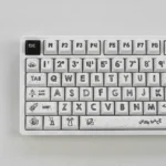 Playful astronaut PBT keycaps: a durable 131-key dye-sub set with crisp space legends on a clean white base, displayed from multiple angles.