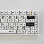 A playful collection of Astronaut PBT keycaps set in a gallery view, showcasing their durable white PBT and crisp dye-sublimated space legends from multiple angles.