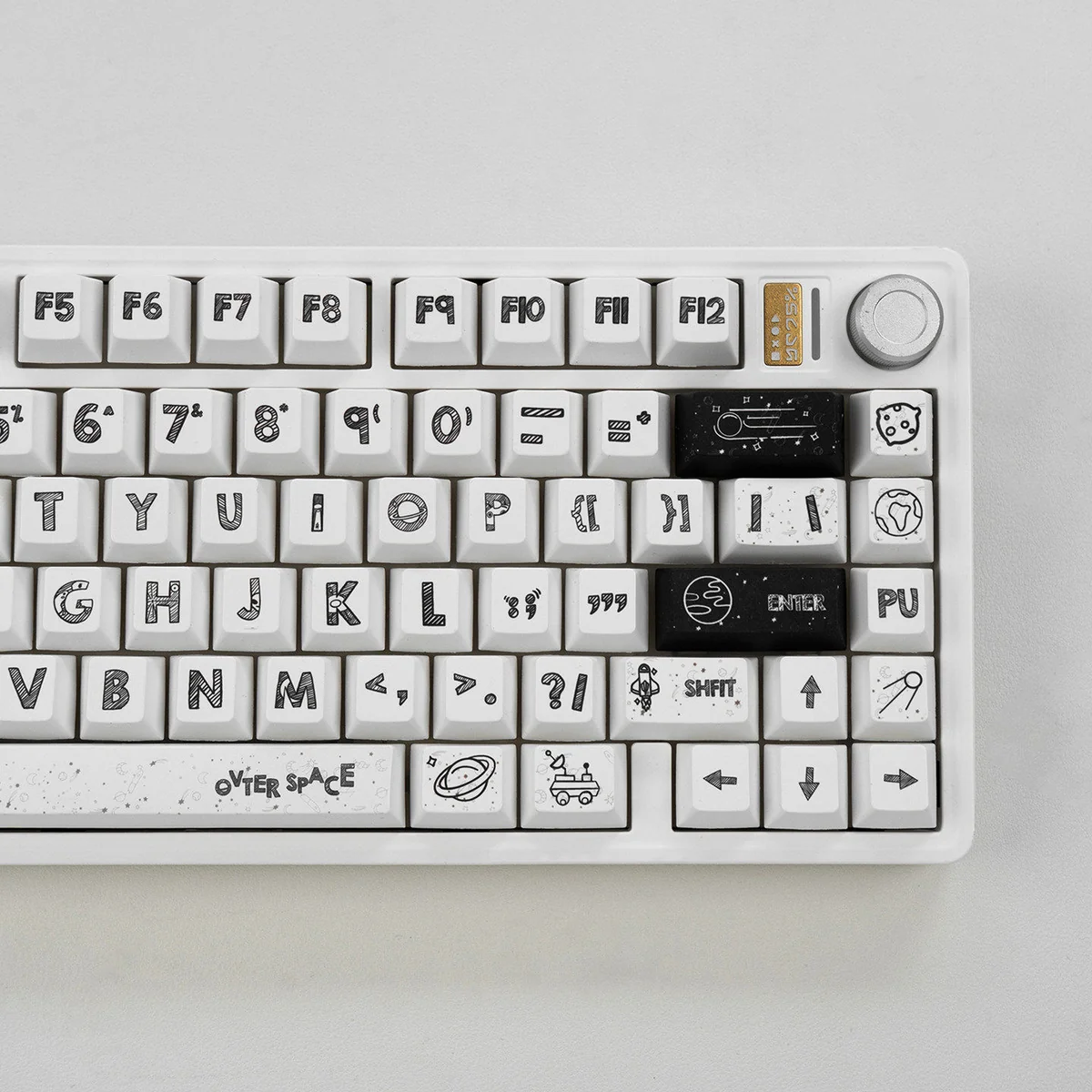 A playful collection of Astronaut PBT keycaps set in a gallery view, showcasing their durable white PBT and crisp dye-sublimated space legends from multiple angles.
