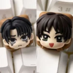 Playful hand-sculpted chibi Eren and Levi Attack on Titan keycap with glossy resin 3D anime heads on a white keyboard.