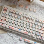 Whimsical Biscuit Diary PBT MOA keycaps from multiple angles, showcasing the delightful cookie motifs and warm creamy PBT texture, evoking cozy.