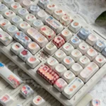 Close-up of Whimsical Biscuit Diary PBT MOA Keycaps, showcasing playful biscuit and cookie motifs on creamy PBT, highlighting the unique.
