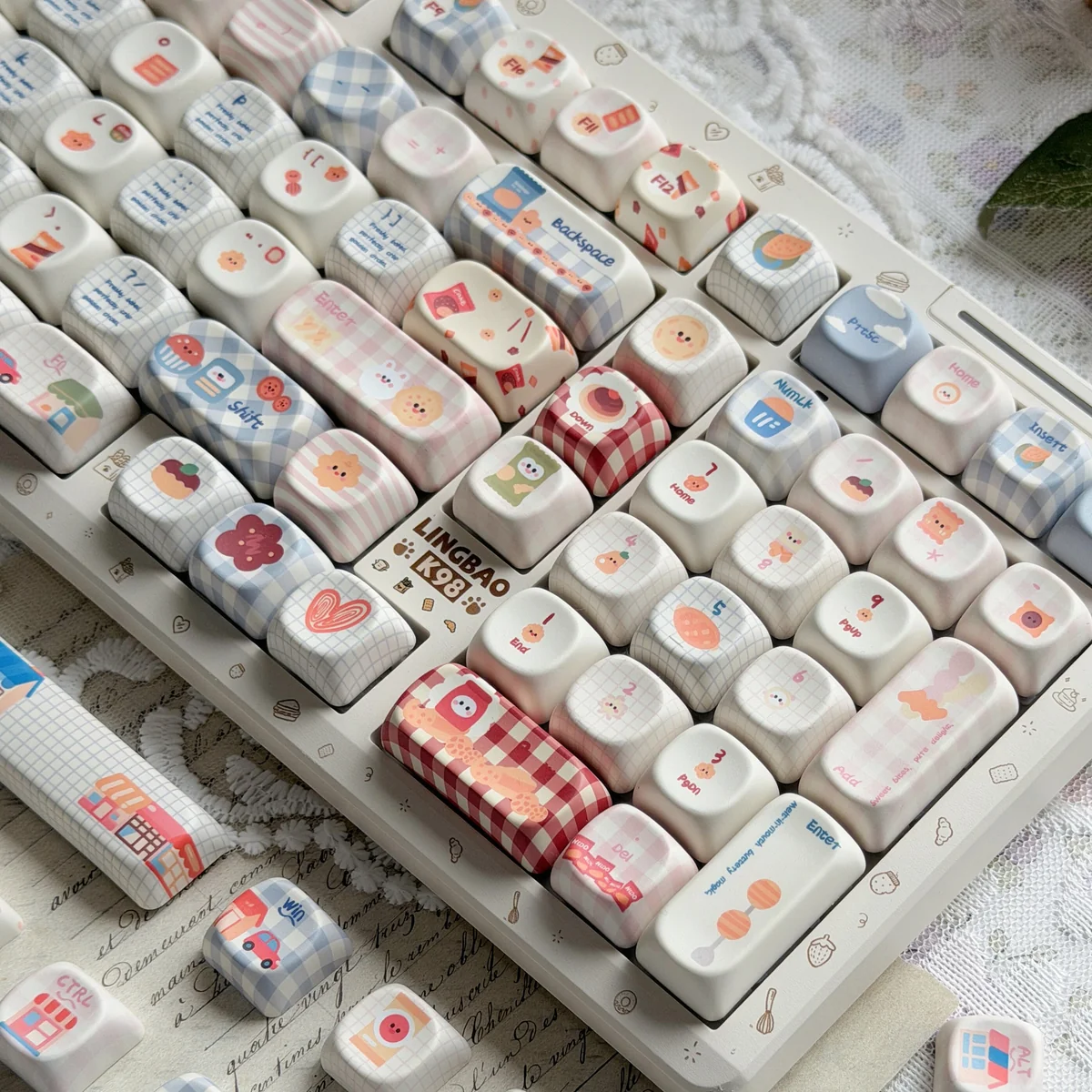 Close-up of Whimsical Biscuit Diary PBT MOA Keycaps, showcasing playful biscuit and cookie motifs on creamy PBT, highlighting the unique.