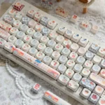 Whimsical Biscuit Diary PBT MOA keycaps arranged, featuring charming biscuit and cookie motifs on creamy PBT, evoking cozy and playful keyboard aesthetics.