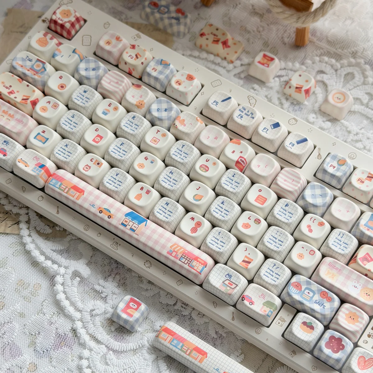 Whimsical Biscuit Diary PBT MOA keycaps arranged, featuring charming biscuit and cookie motifs on creamy PBT, evoking cozy and playful keyboard aesthetics.