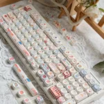 A close-up view of the Whimsical Biscuit Diary PBT MOA Keycap Set, showcasing adorable biscuit and cookie designs on creamy PBT, exuding a cozy.