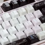 Ceramic Keycap Set: Black Veil Pink Dimple. Exquisite smooth ceramic from varied angles, showcasing delicate dark and pink accents for tactile luxury visual.