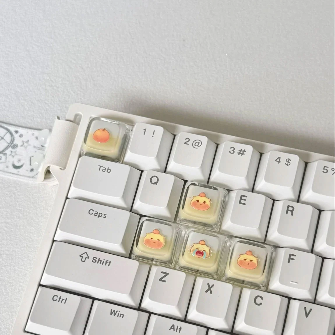 A charming set of 5 handcrafted, translucent Capybara Couple Lulu XDA keycaps, showcasing their playful design and glowing effect on a personalized keyboard.