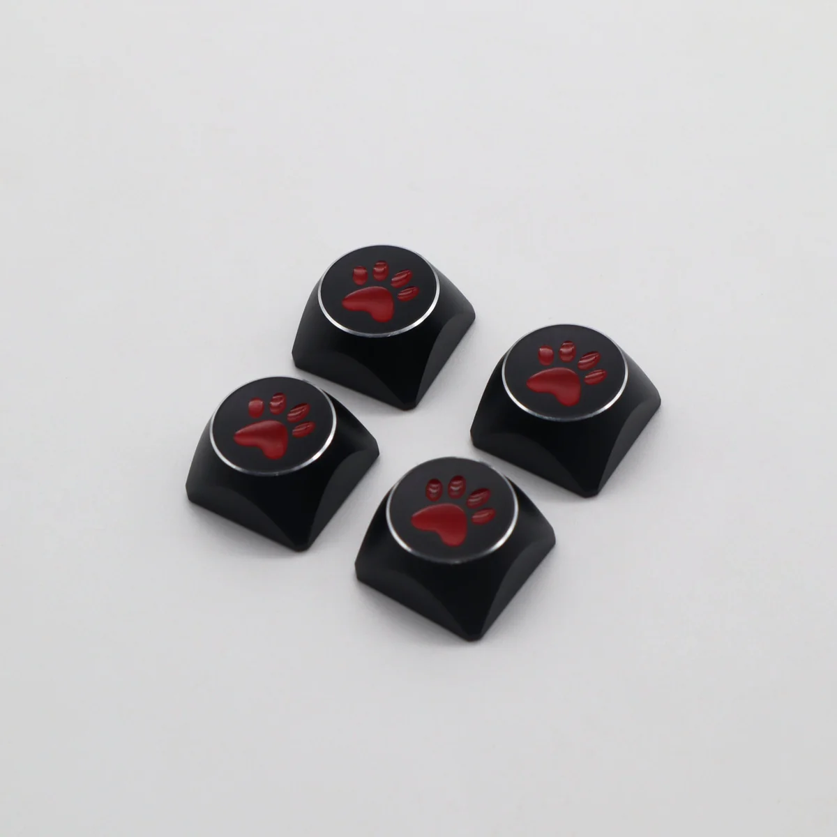 Angled view of the artistic aluminum cat paw keycaps, showcasing their vibrant electroplated finish and premium metal craftsmanship.